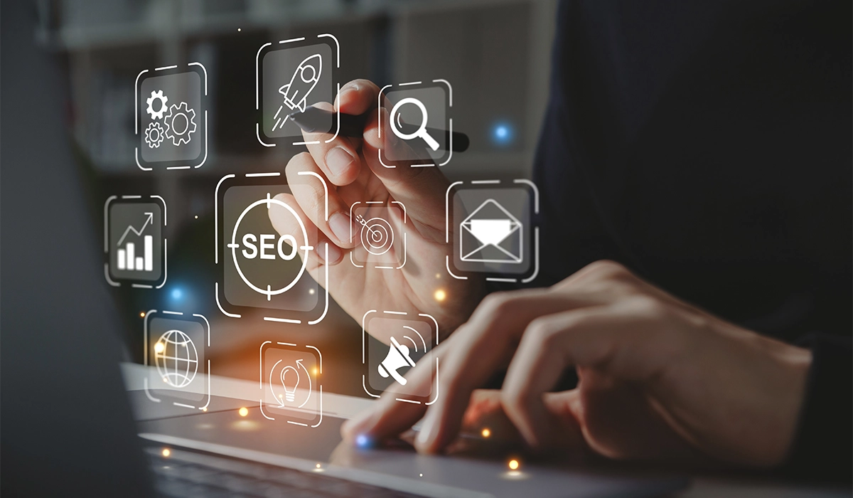 SEO concept showing digital marketing icons, search optimization tools, and business growth strategy on a laptop screen