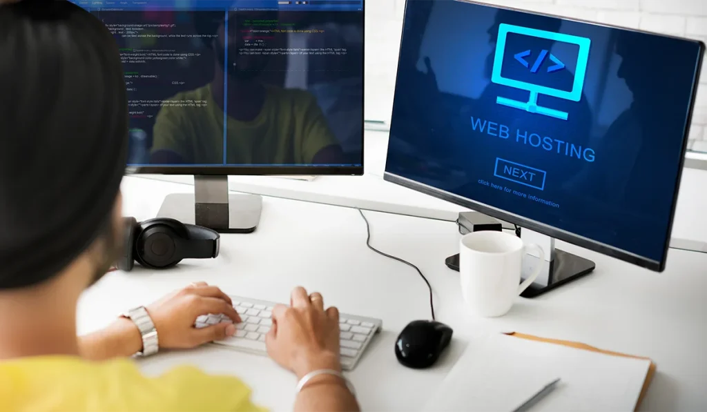 Person working at a computer with dual monitors displaying web hosting and coding interfaces